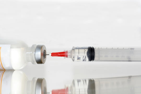 Syringe retrieving medication. 