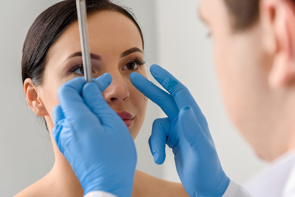 doctor examining patient's nose