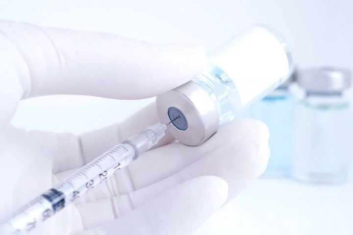 Botox-type injectable drawn into syringe from vial