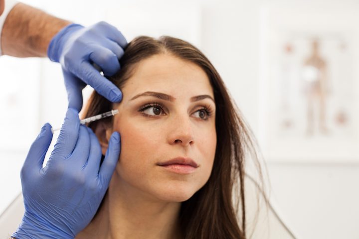 Young woman receiving Botox injections.