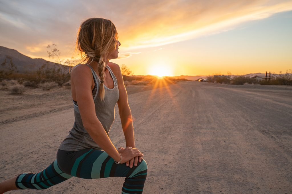 Woman stretching before early morning run