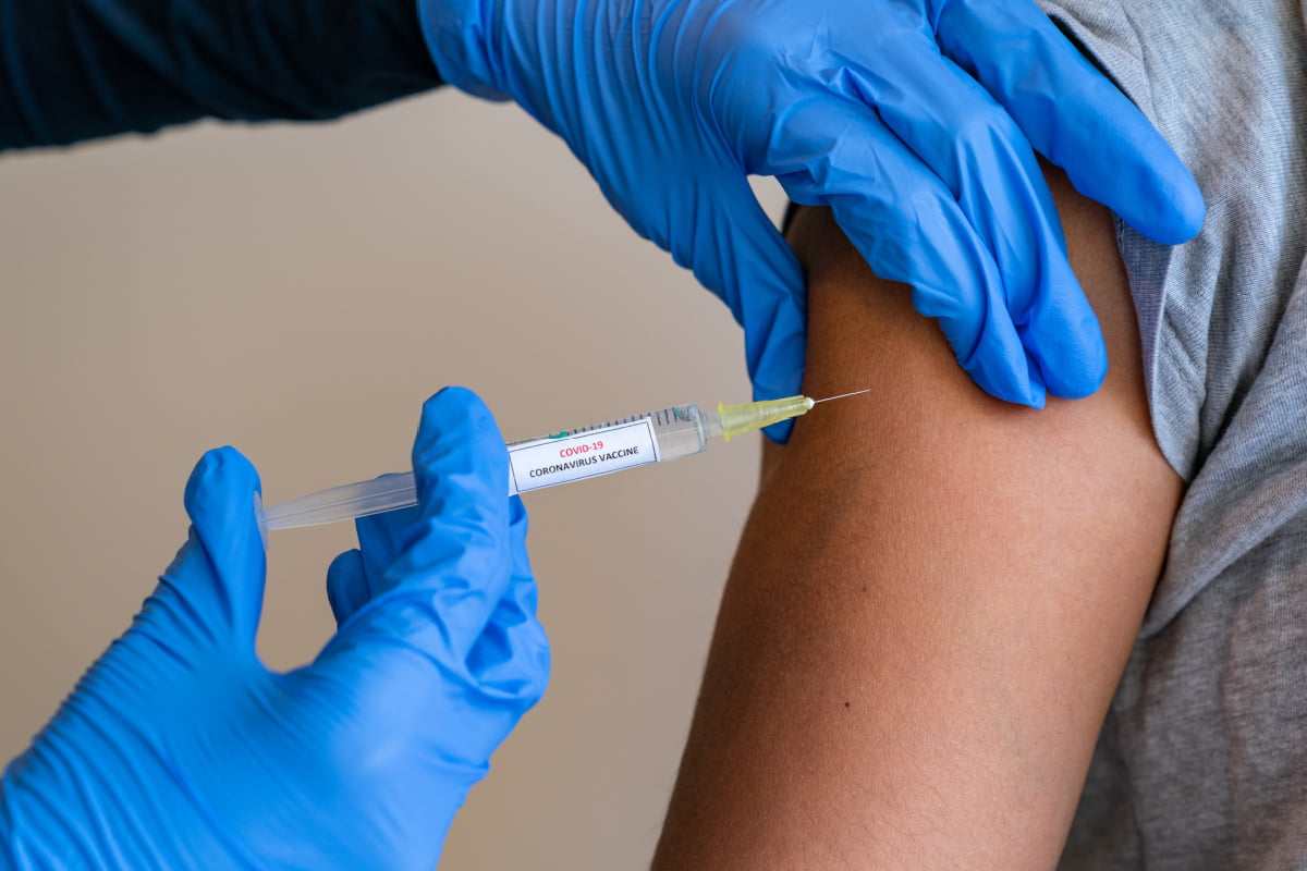 Female doctor giving a COVID vaccine