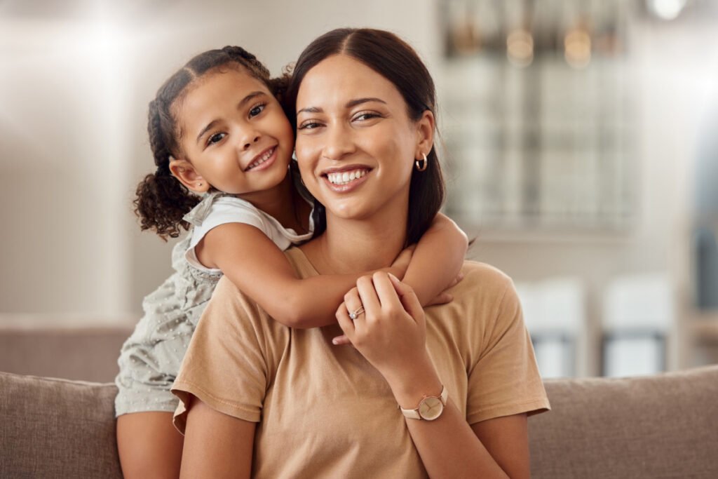 Young mother and daughter smiling and happy