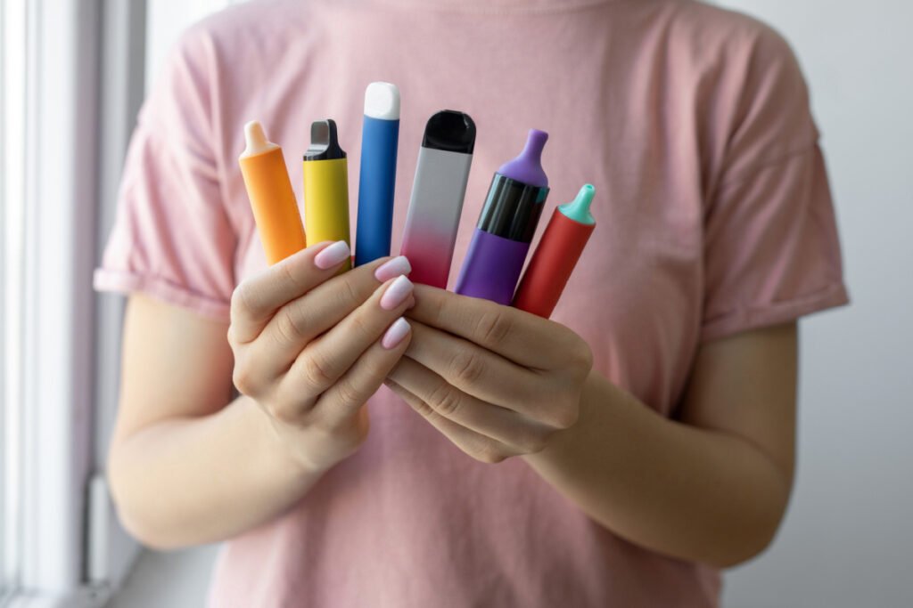 Woman holding collection of vape pens